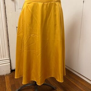 Unique Vintage Gold or Mustard Colored skirt. 28 in long.  Size is 8-10.